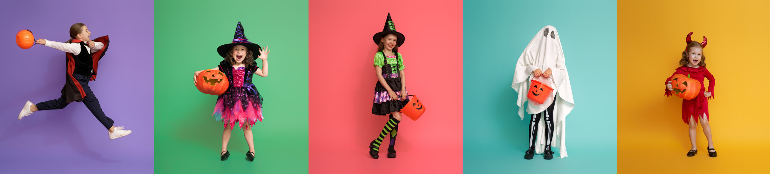 Children in Halloween costumes with pumpkins