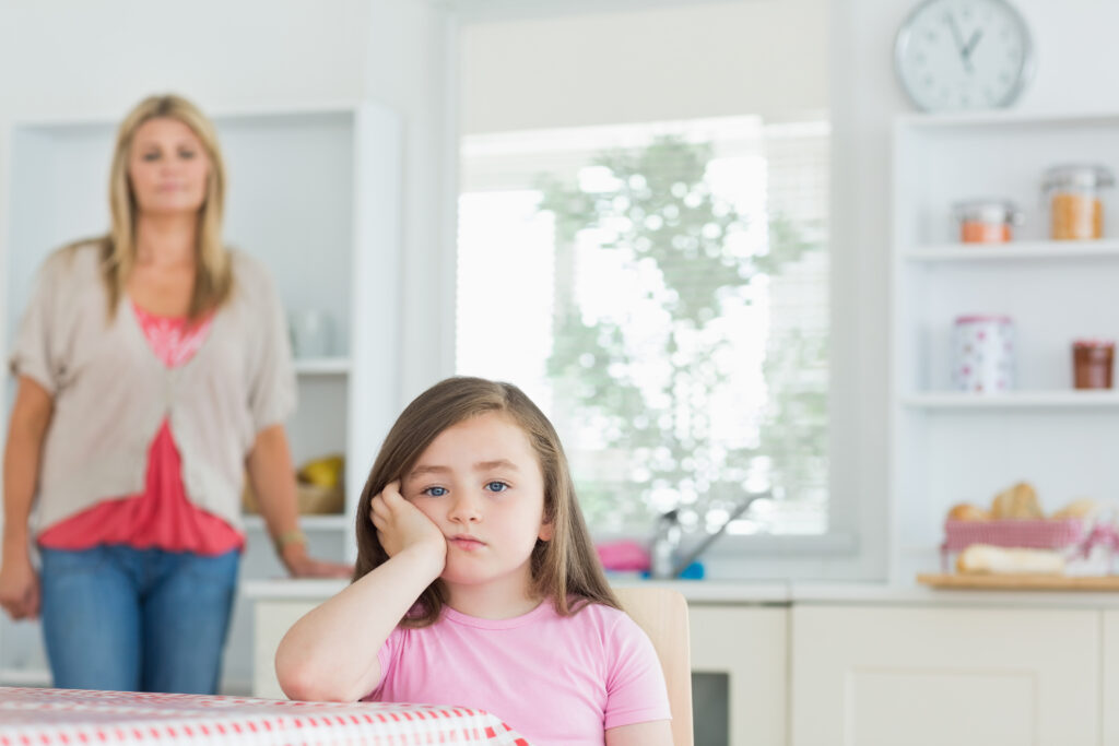 Child sitting at kitchen table.